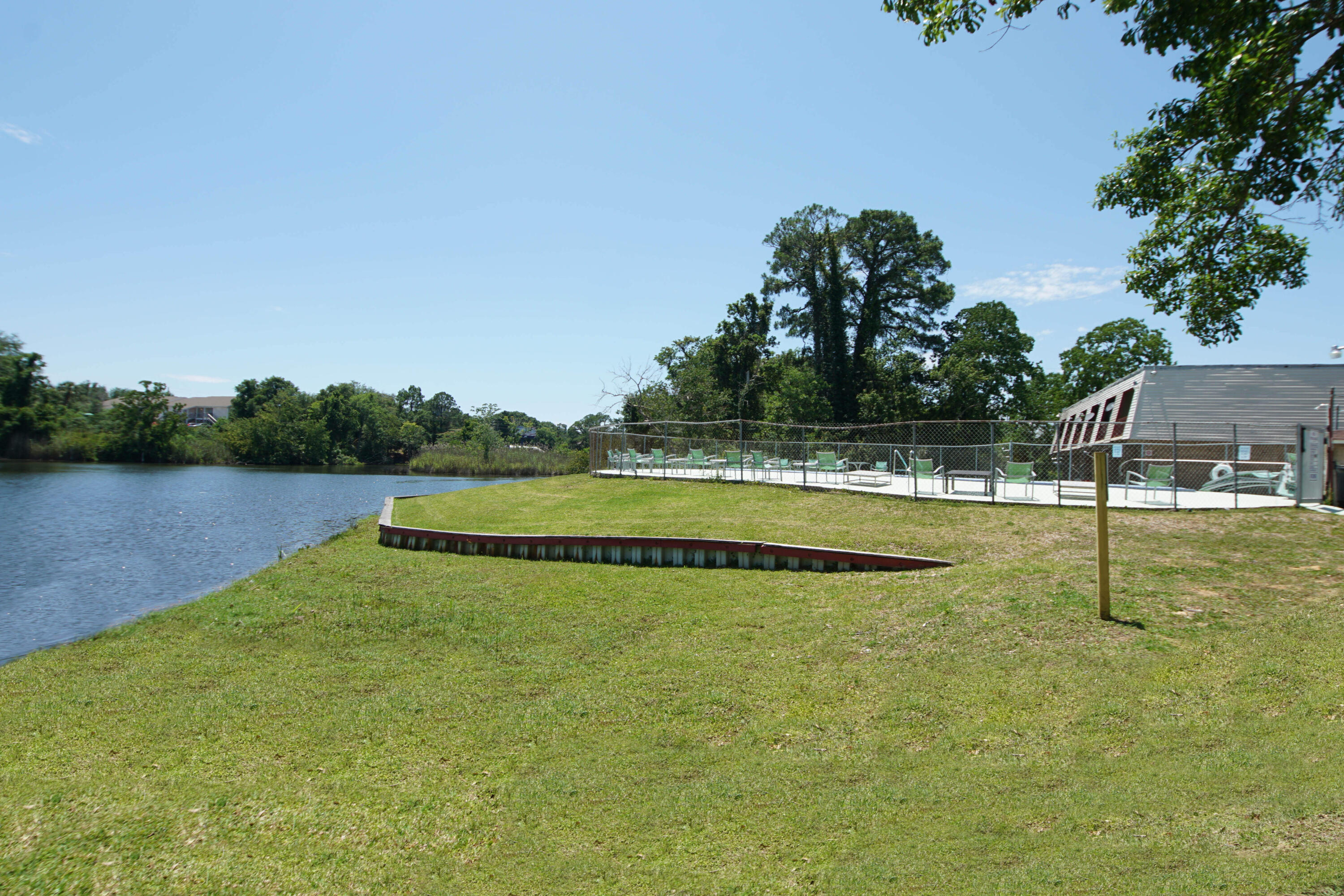 210 Pelham Road, Unit 219C Fort Walton Beach, FL 32547 - Photo 22 of 23 a view of a swimming pool with an outdoor space and seating area