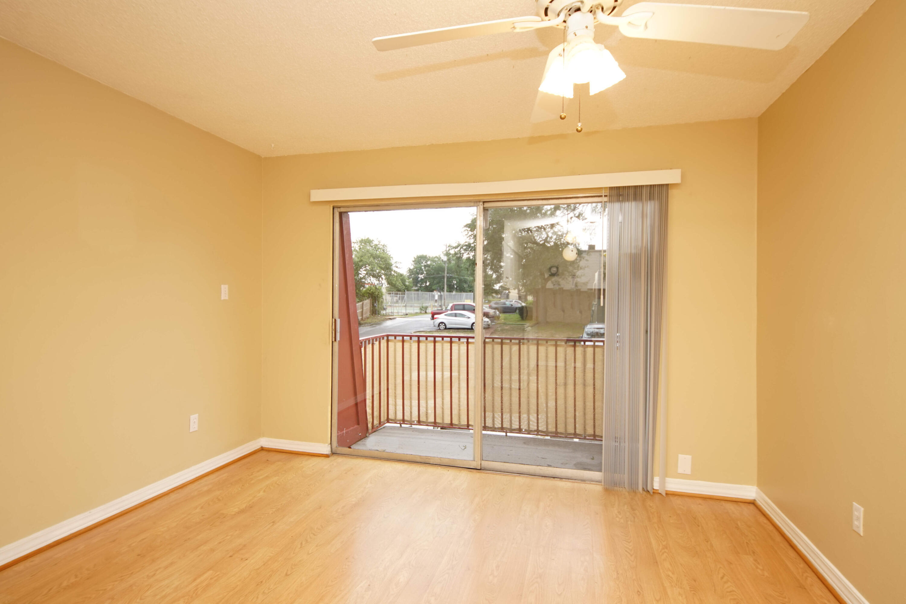 210 Pelham Road, Unit 219C Fort Walton Beach, FL 32547 - Photo 4 of 23 a view of a room with wooden floor and windows