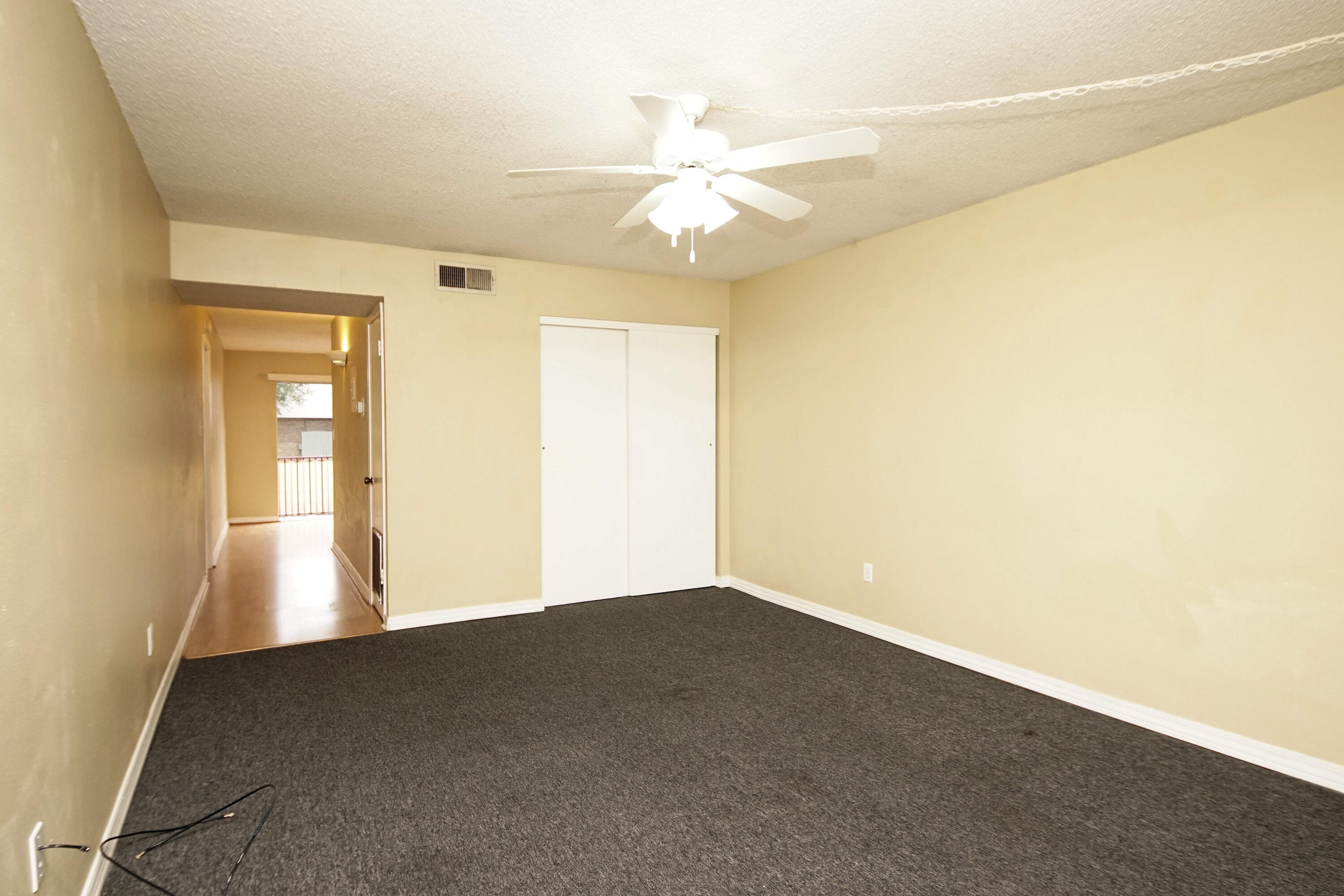 210 Pelham Road, Unit 219C Fort Walton Beach, FL 32547 - Photo 6 of 23 a view of an empty room with chandelier fan and a window