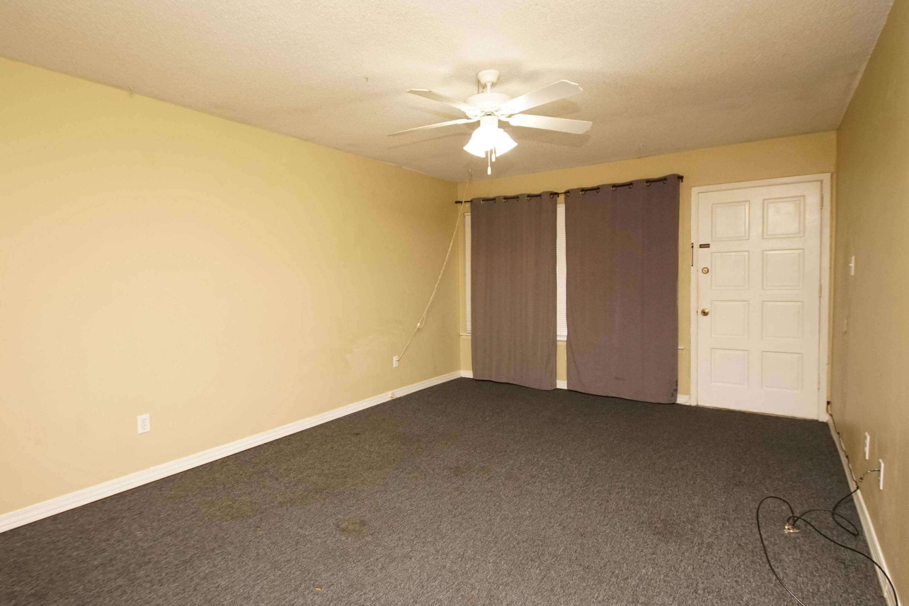 210 Pelham Road, Unit 219C Fort Walton Beach, FL 32547 - Photo 7 of 23 an empty room with a chandelier fan and windows