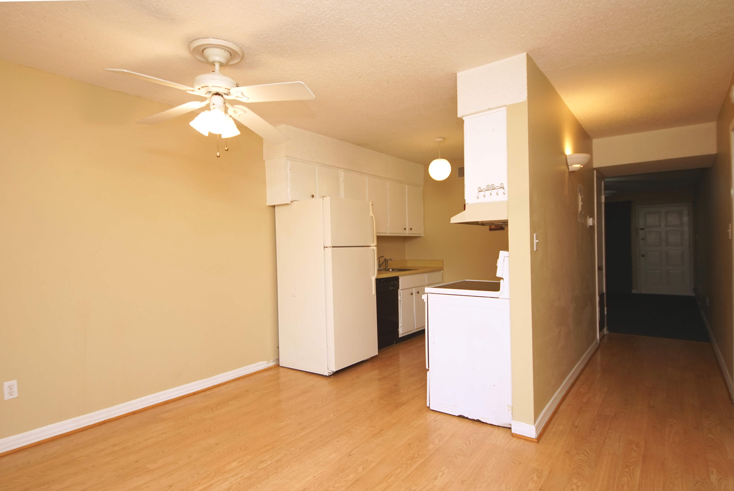 210 Pelham Road, Unit 219C Fort Walton Beach, FL 32547 - Photo 8 of 23 a view of a kitchen with a sink and a refrigerator
