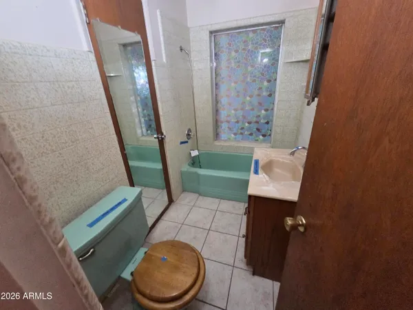 a view of a livingroom with an empty space and a window