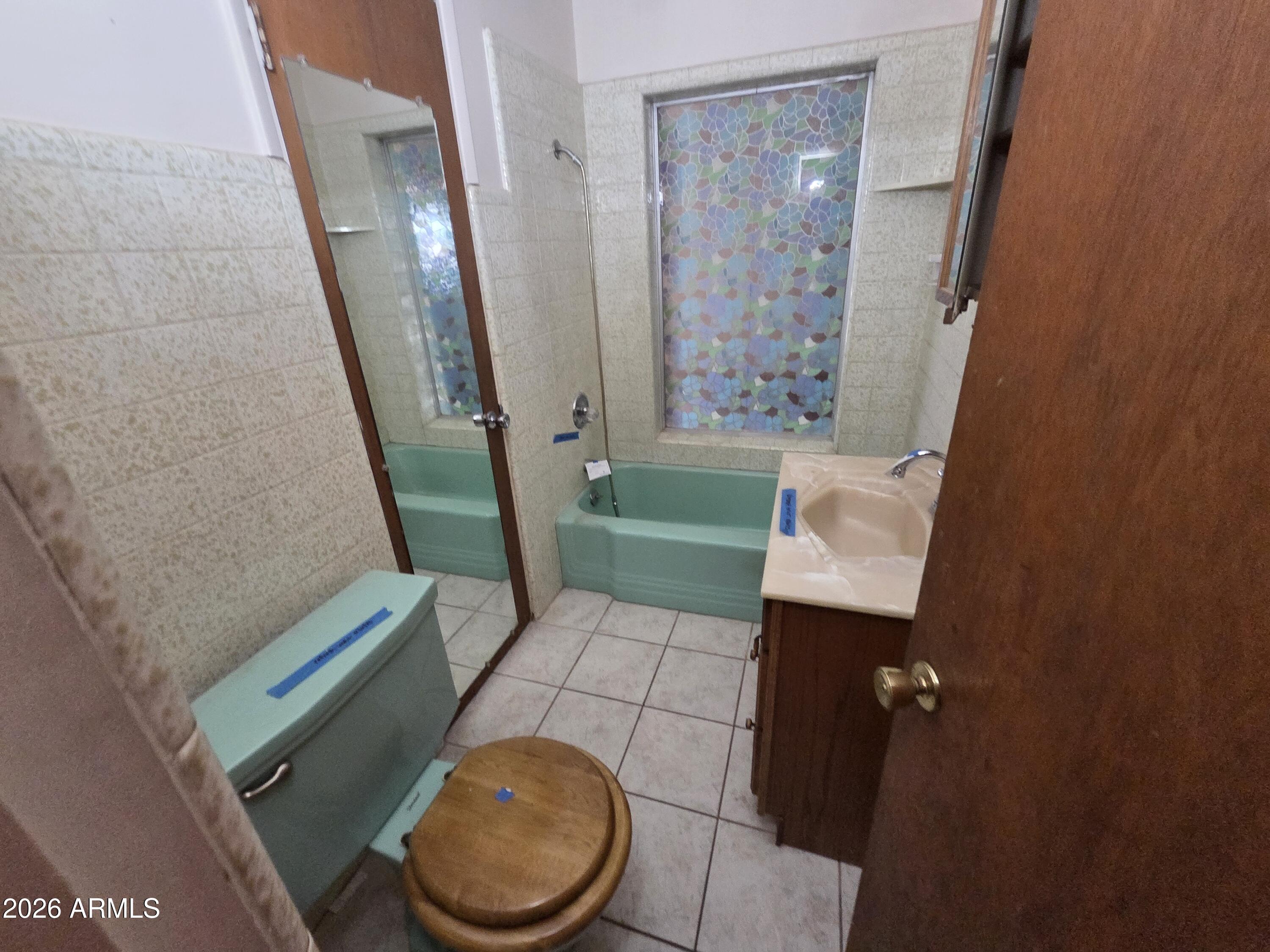 3237 West Pierce Street Phoenix, AZ 85009 - Photo 7 of 20 a bathroom with a sink toilet and shower
