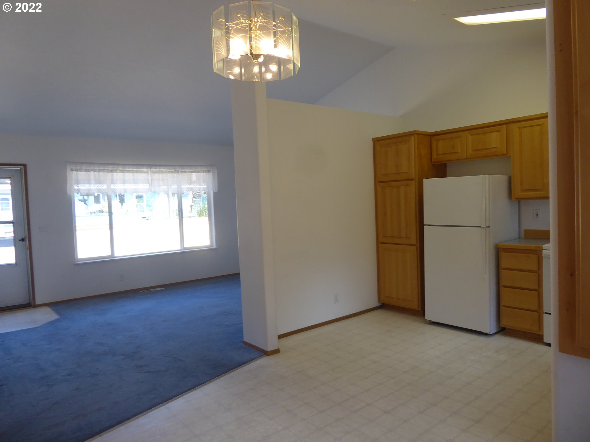 5522 E Street Springfield, OR 97478 - Photo 4 of 11 an empty room with chandelier fan and windows