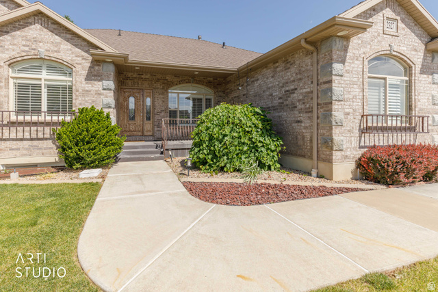 2327 Bluff Ridge Drive Syracuse, UT 84075 - Photo 5 of 66 Brick exterior featuring stone accents and arched windows