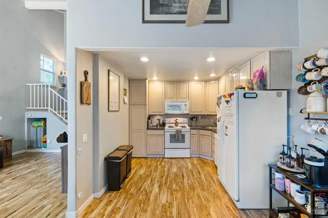 a kitchen with stainless steel appliances granite countertop a refrigerator and a stove top oven