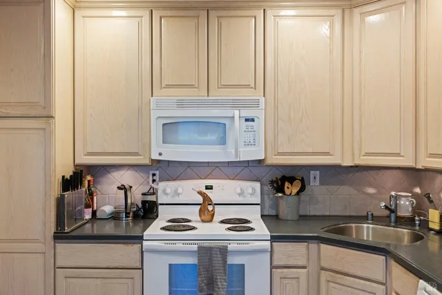 a kitchen with cabinets appliances and a sink