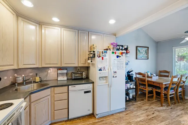 a kitchen with stainless steel appliances granite countertop a refrigerator and a stove top oven