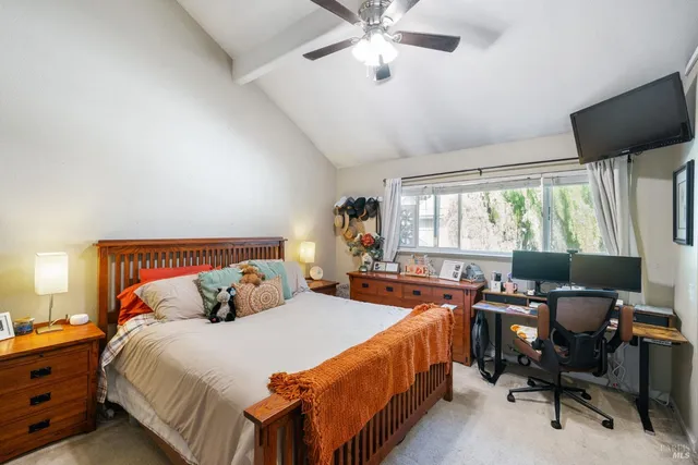 a bedroom with a bed and a large window