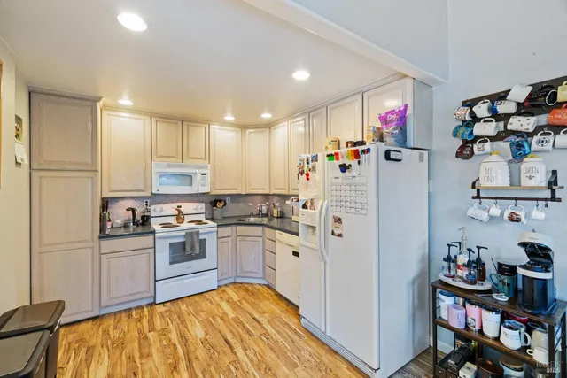 a kitchen with refrigerator and cabinets