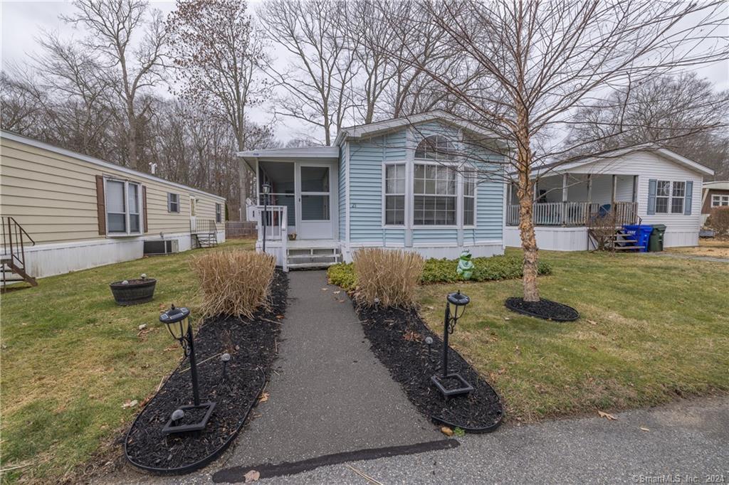 91 Buddington Road, Unit 21 Groton, CT 06340 - Photo 1 of 1 Front view of this cozy mobile home taken from the 2 parking space in front of the unit