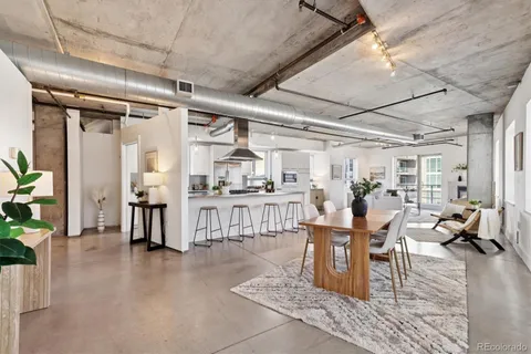 a living room with lots of furniture and a chandelier