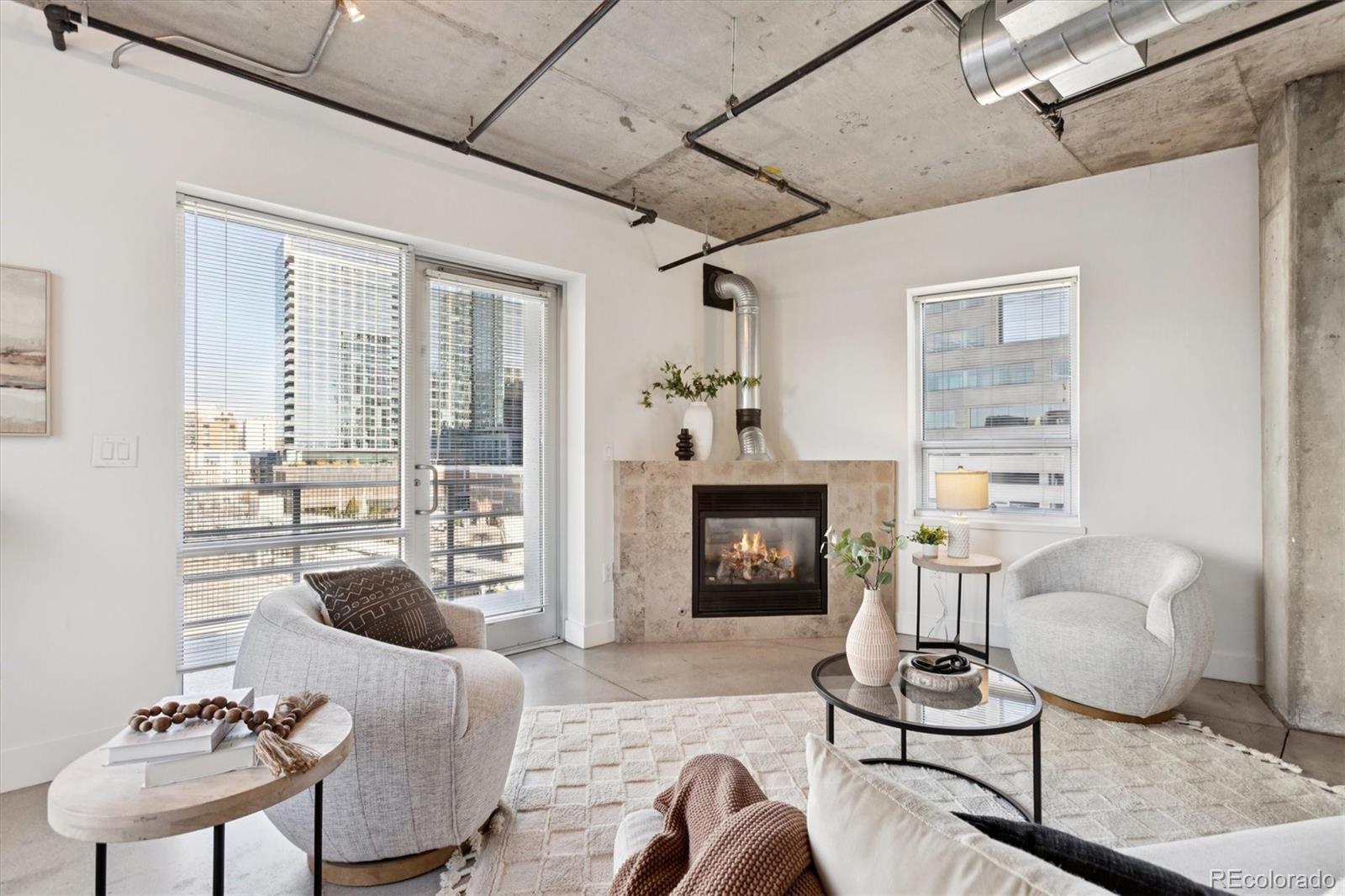 1610 Little Raven Street, Unit 511 Denver, CO 80202 - Photo 11 of 34 a living room with furniture and a fireplace