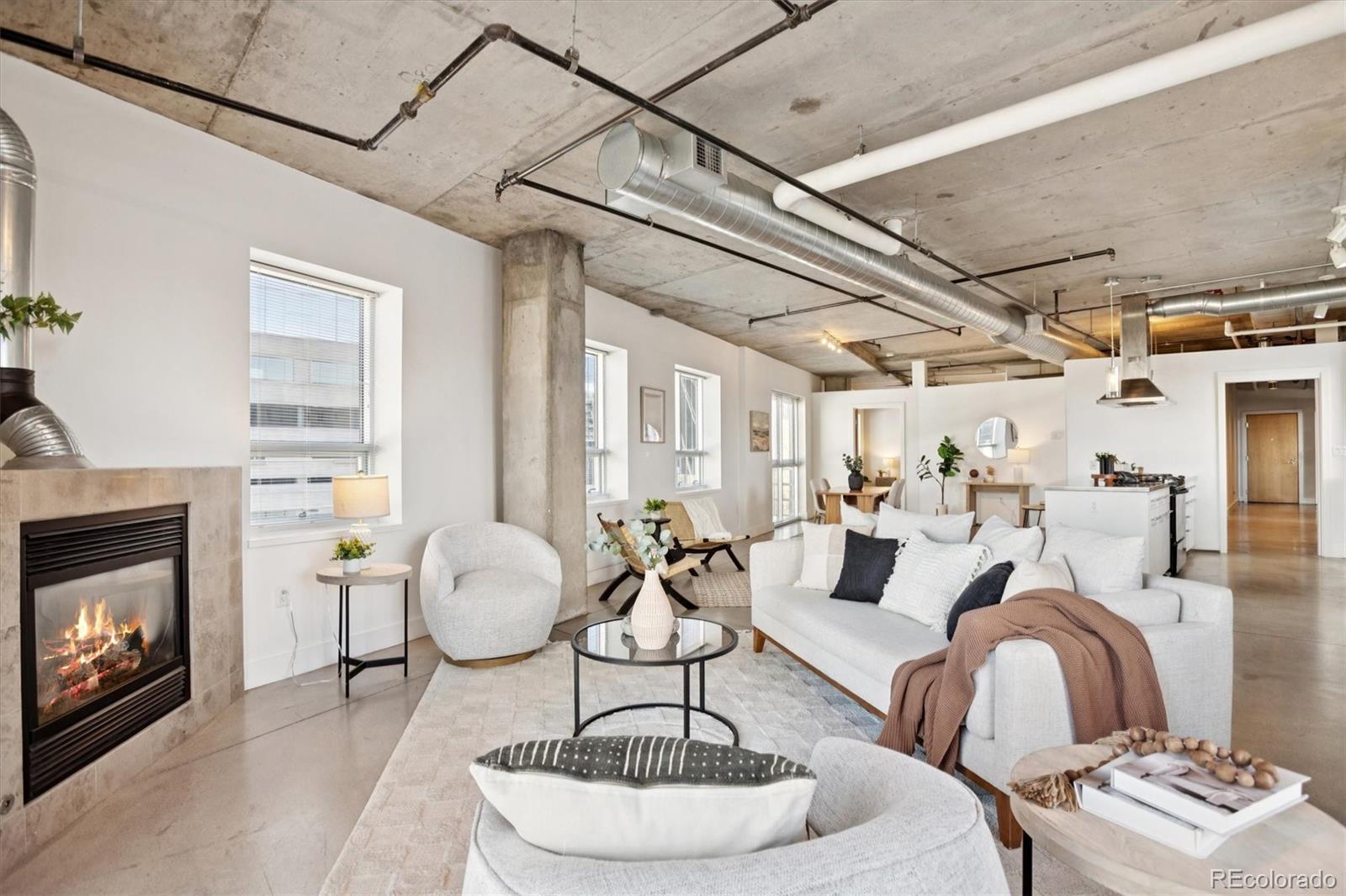 1610 Little Raven Street, Unit 511 Denver, CO 80202 - Photo 14 of 34 a living room with furniture and a fireplace