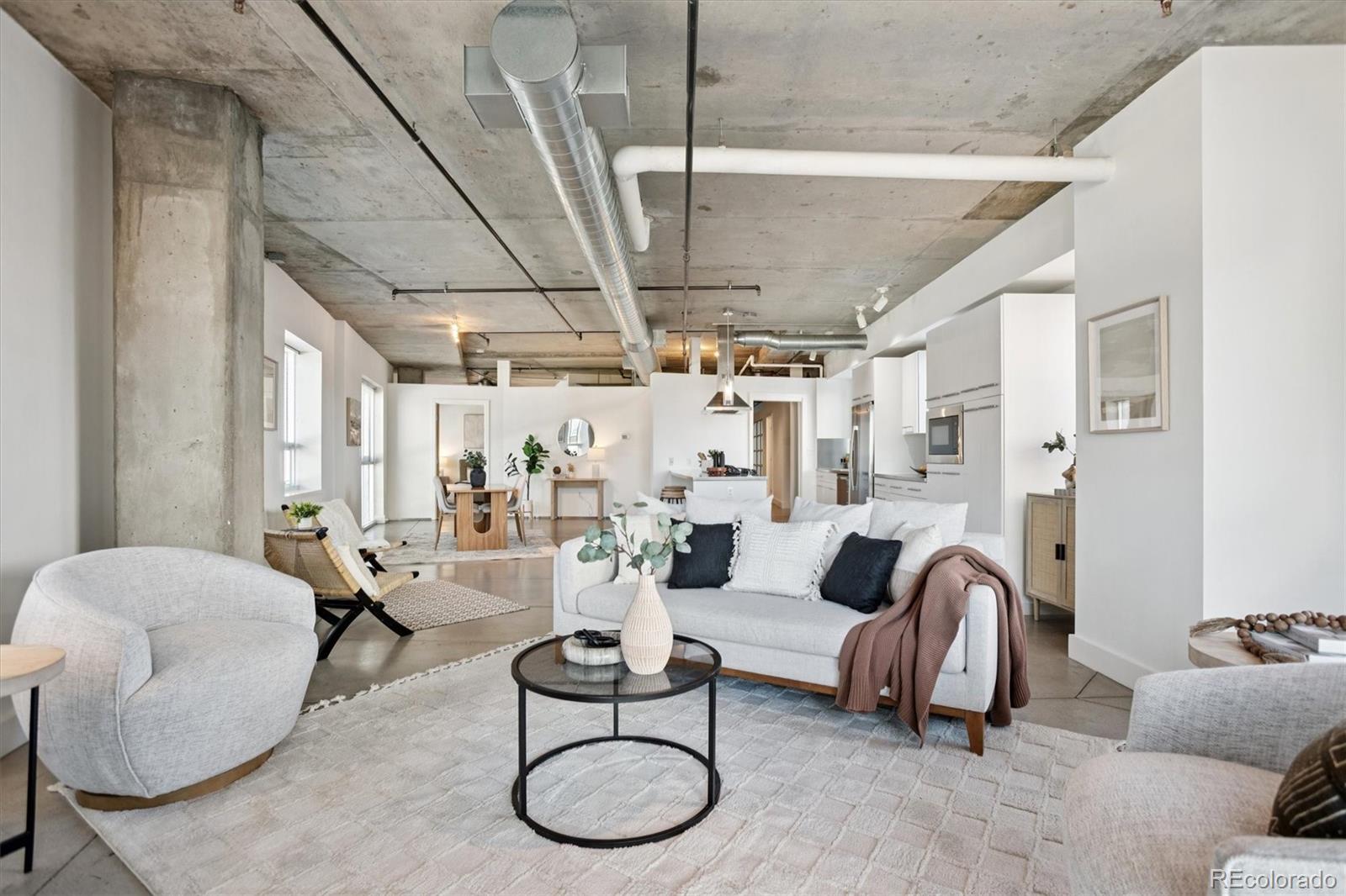 1610 Little Raven Street, Unit 511 Denver, CO 80202 - Photo 15 of 34 a living room with furniture and a chandelier