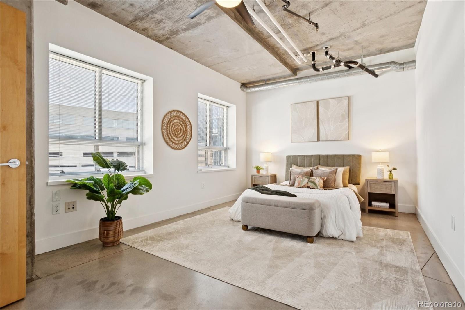 1610 Little Raven Street, Unit 511 Denver, CO 80202 - Photo 19 of 34 a bed room with bed and a potted plant