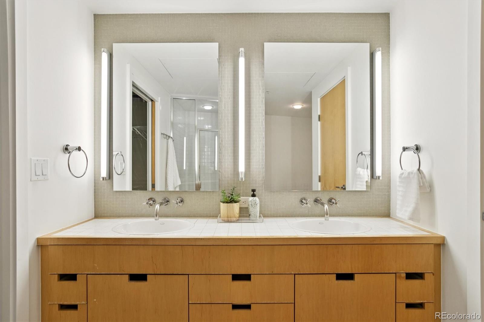 1610 Little Raven Street, Unit 511 Denver, CO 80202 - Photo 22 of 34 a bathroom with a sink and a mirror