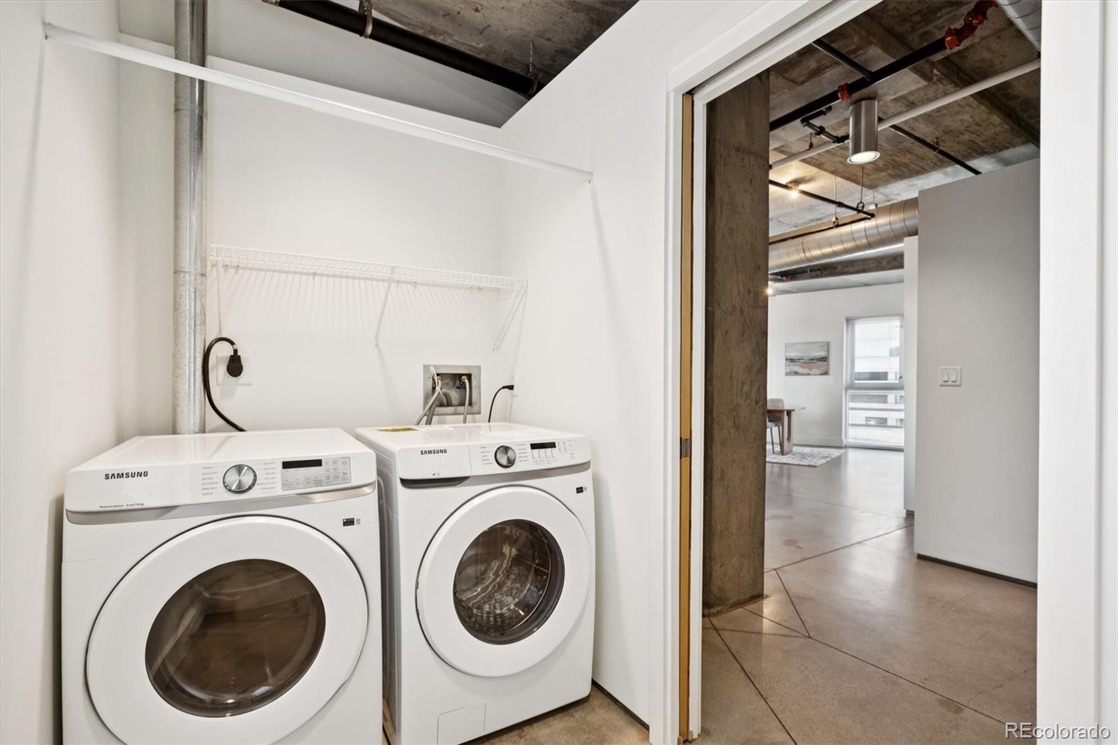 1610 Little Raven Street, Unit 511 Denver, CO 80202 - Photo 24 of 34 a view of a hallway with washer and dryer