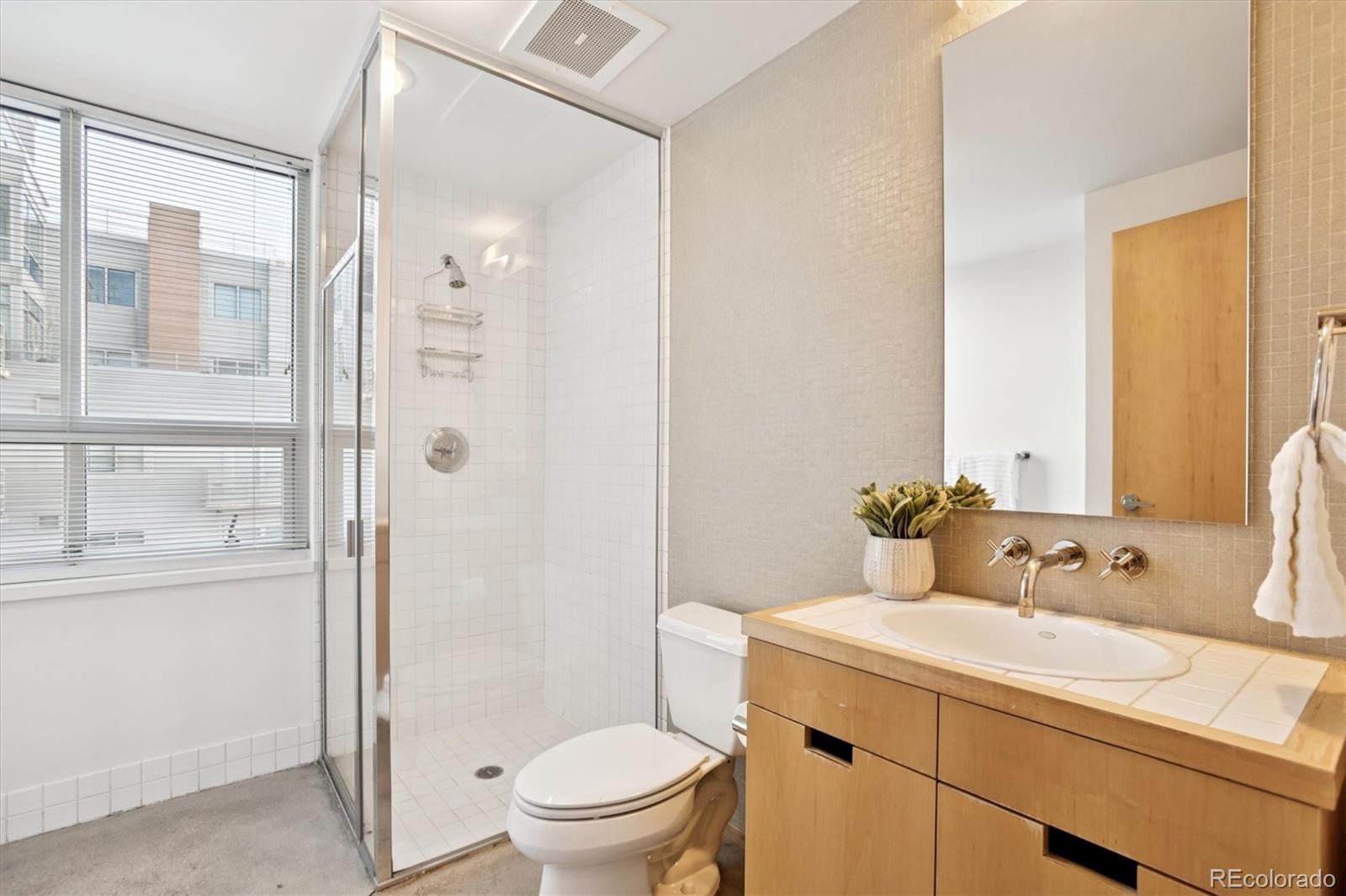 1610 Little Raven Street, Unit 511 Denver, CO 80202 - Photo 26 of 34 a bathroom with a sink toilet and shower