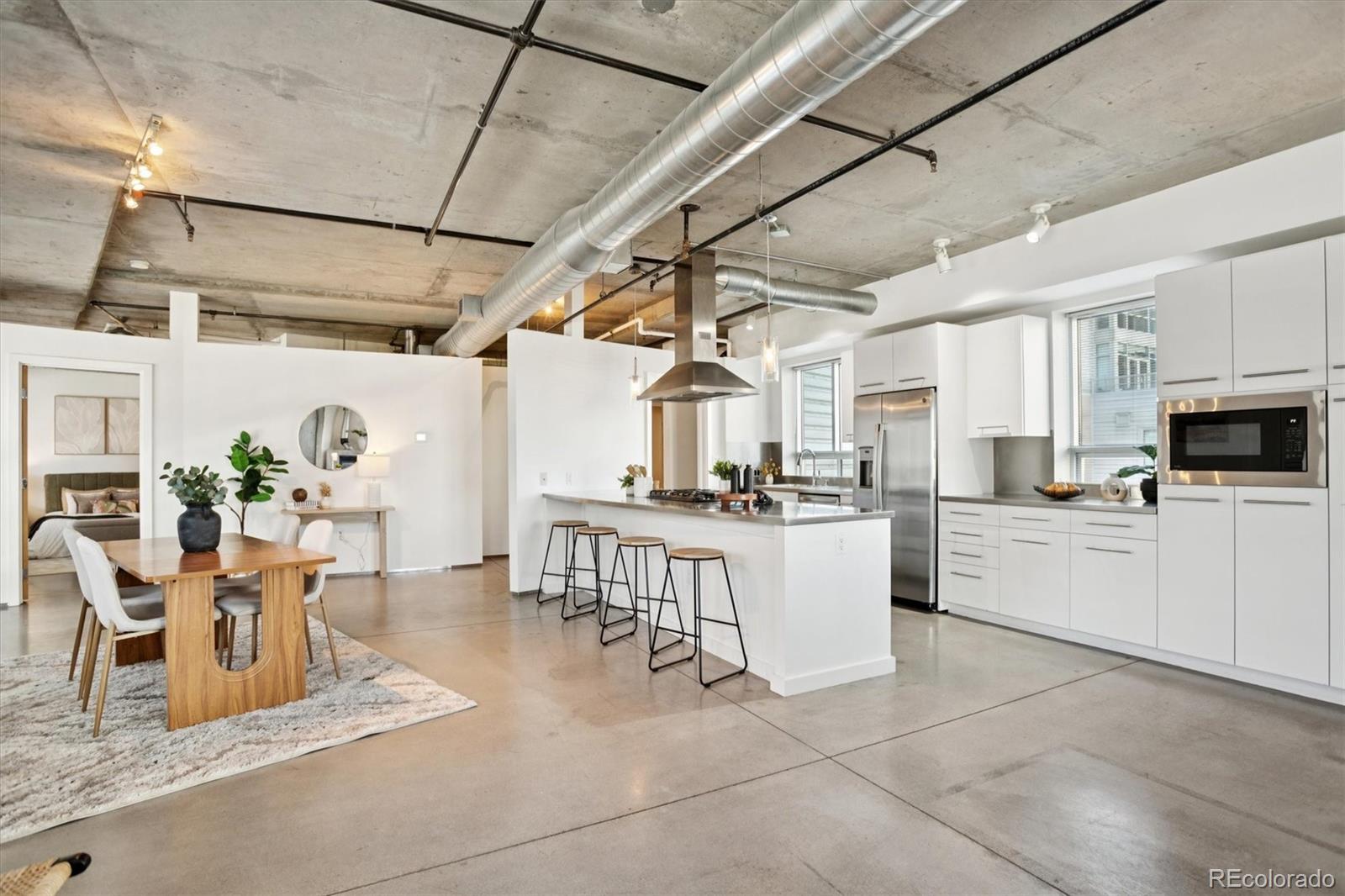 1610 Little Raven Street, Unit 511 Denver, CO 80202 - Photo 3 of 34 a kitchen with a table and chairs in it