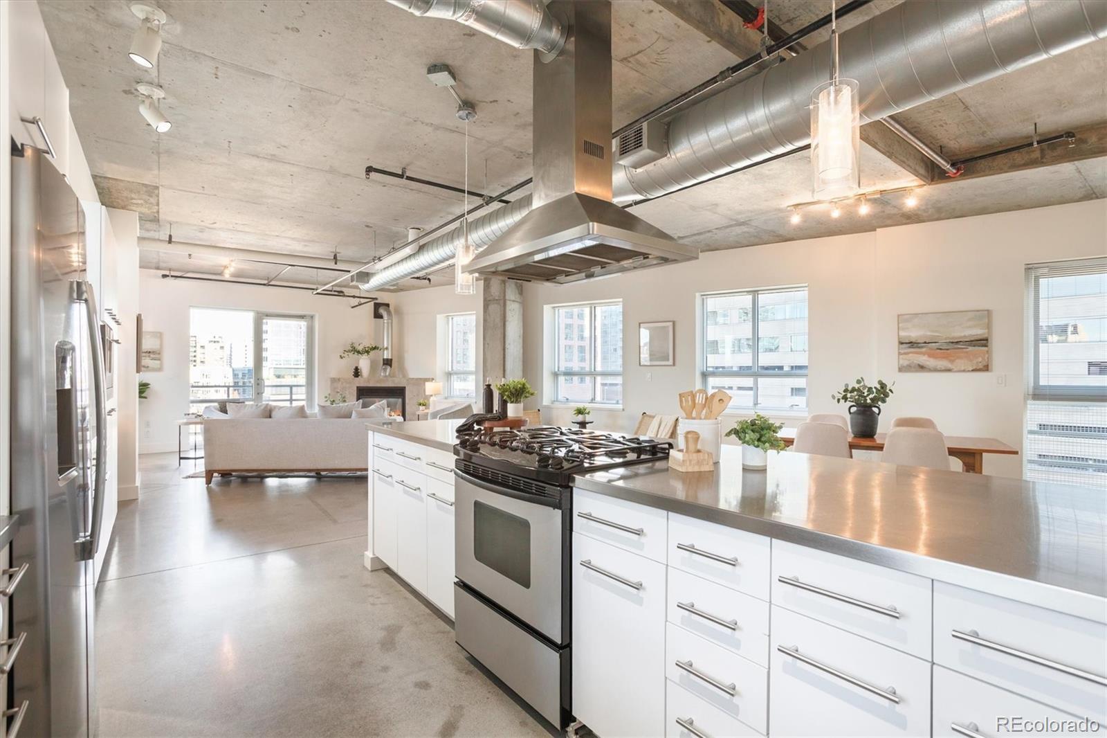 1610 Little Raven Street, Unit 511 Denver, CO 80202 - Photo 7 of 34 a kitchen with a stove and white cabinets