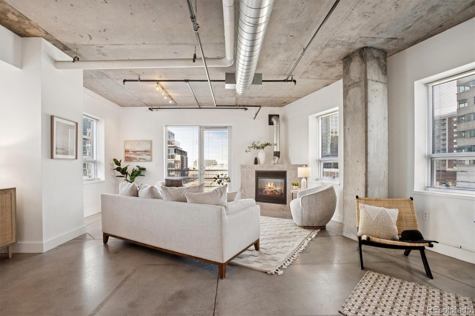 1610 Little Raven Street, Unit 511 Denver, CO 80202 - Photo 9 of 34 a living room with furniture and a chandelier