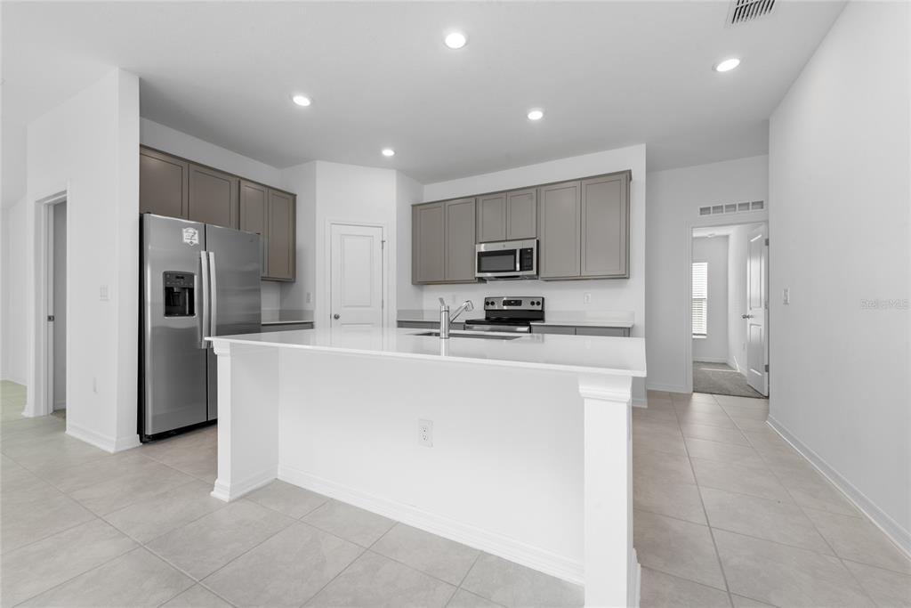 338 Rustic Rail Dr Lake Lake Wales, FL 33859 - Photo 4 of 22 a large kitchen with cabinets and stainless steel appliances