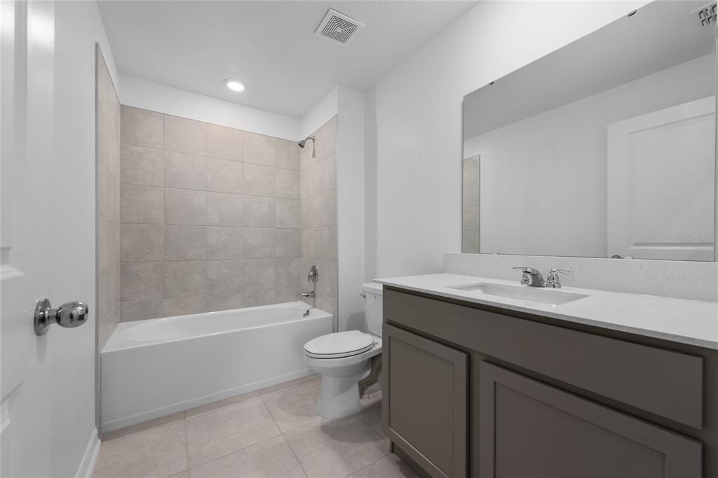 338 Rustic Rail Dr Lake Lake Wales, FL 33859 - Photo 10 of 22 a bathroom with a granite countertop sink a toilet and shower
