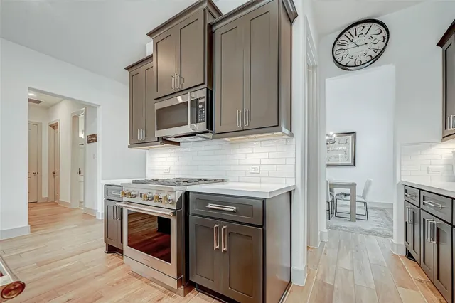 a kitchen with stainless steel appliances granite countertop a stove and a refrigerator