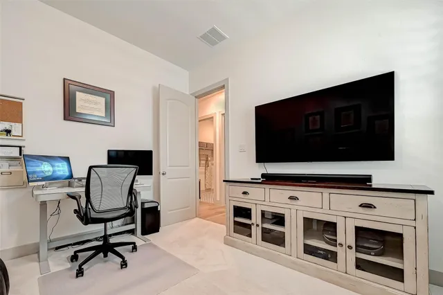 a view of a livingroom with furniture and a flat screen tv
