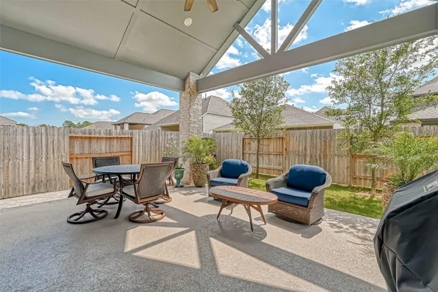 a building outdoor space with patio furniture and potted plants