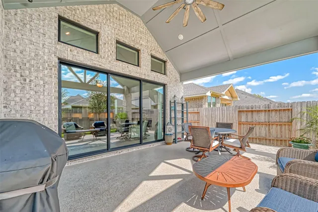 a living room with furniture a rug and a large window