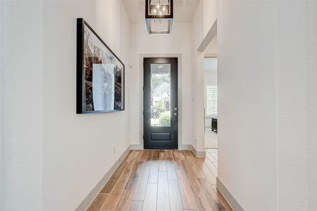 a view of hallway with wooden floor and stairs