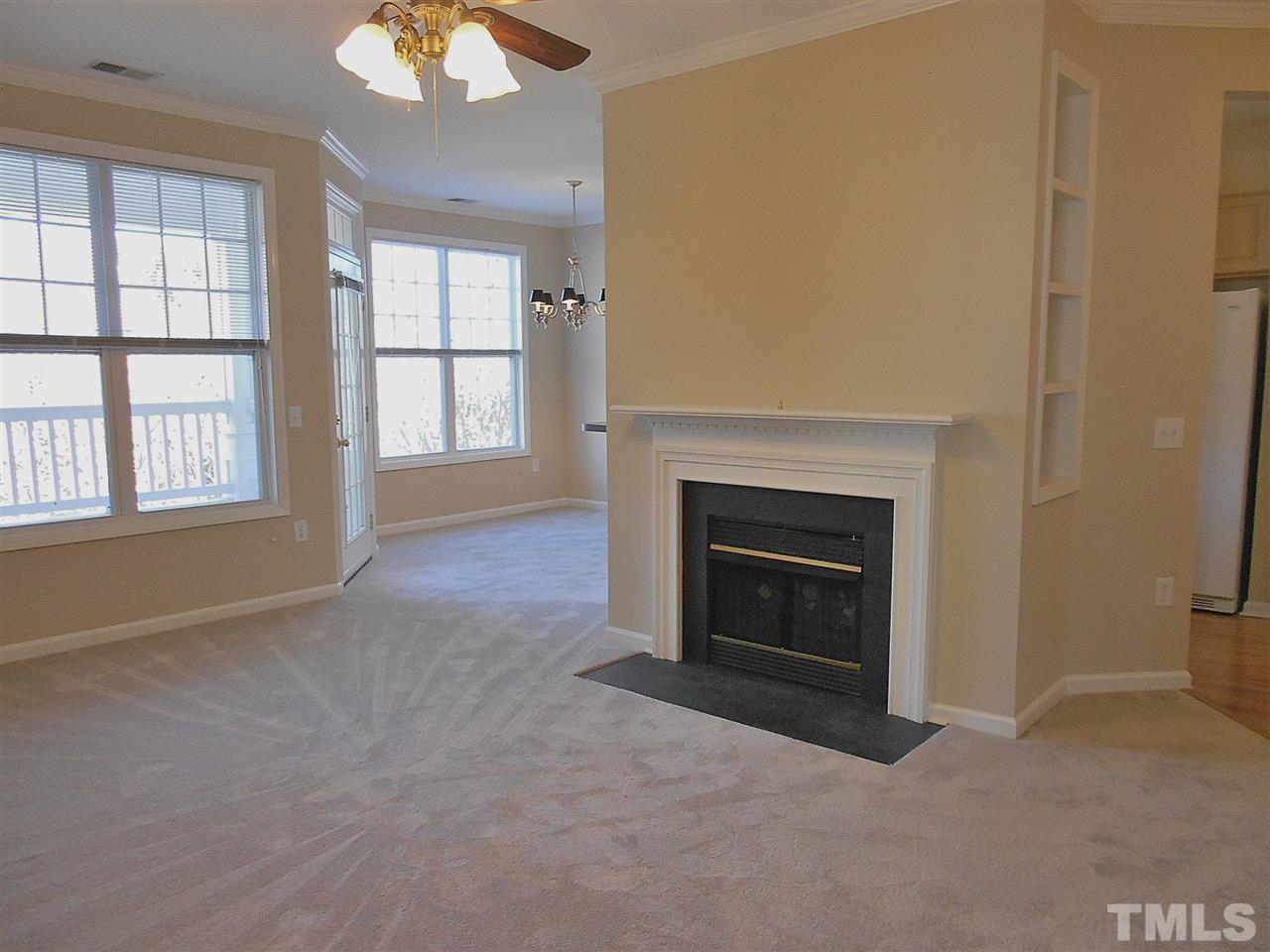 ...has new carpet and paint, built-in bookshelves, crown molding, and a ceiling fan with light kit.