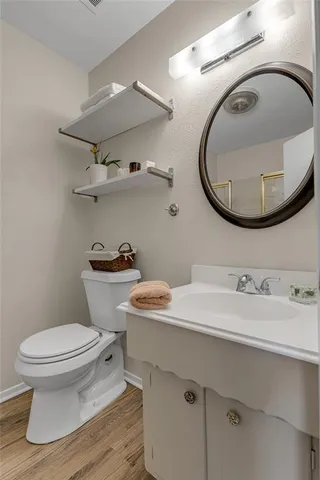 a bathroom with a sink a toilet and a mirror