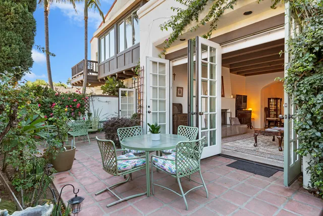 a view of a patio with a table and chairs and potted plants