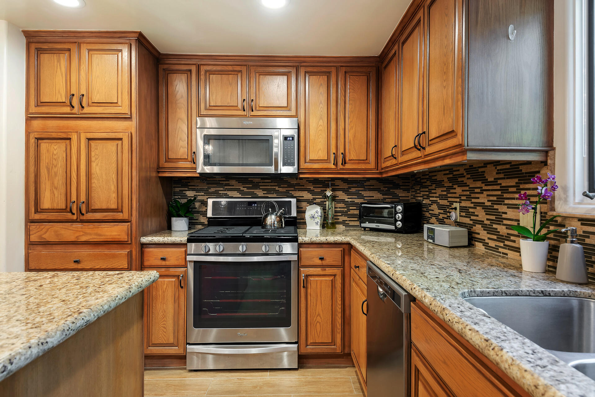 Undisclosed Address Santa Barbara, CA 93101 - Photo 15 of 25 a kitchen with granite countertop a sink stove and cabinets