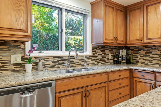 a kitchen with granite countertop a sink and a window