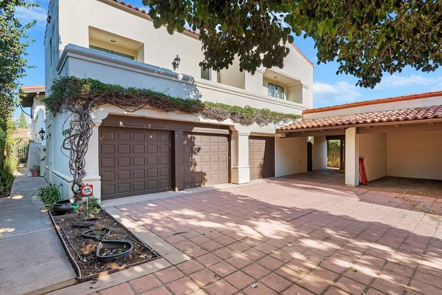 a front view of a building with a yard and a garage