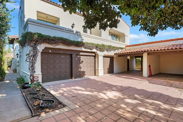 a front view of a building with a yard and a garage