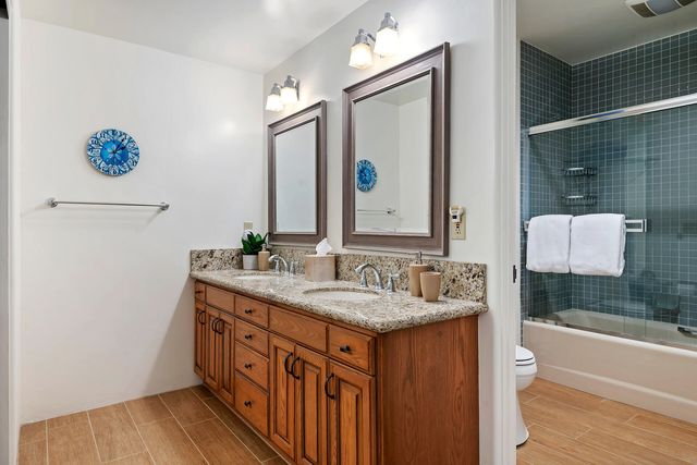 a bathroom with a sink a vanity and a mirror