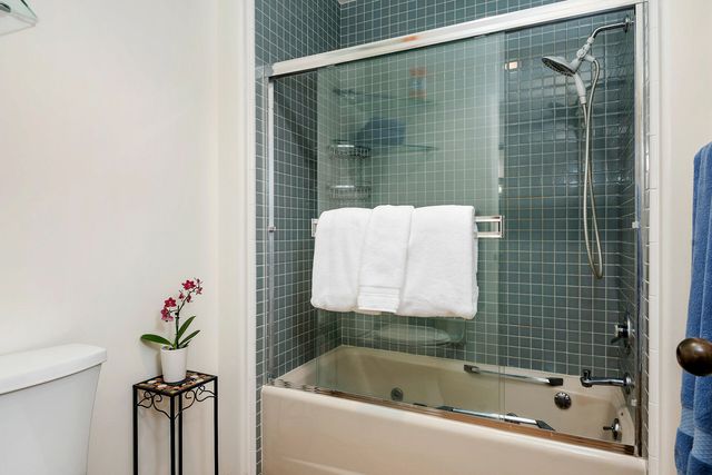 a bathroom with a shower a bathtub and a shower