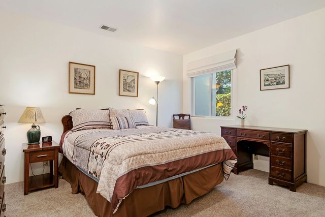 a bedroom with a bed and a table