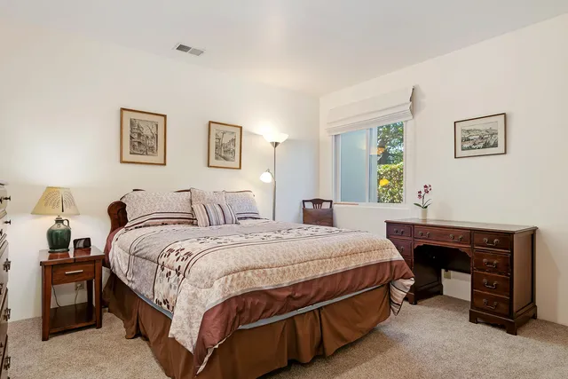 a bedroom with a bed and a table