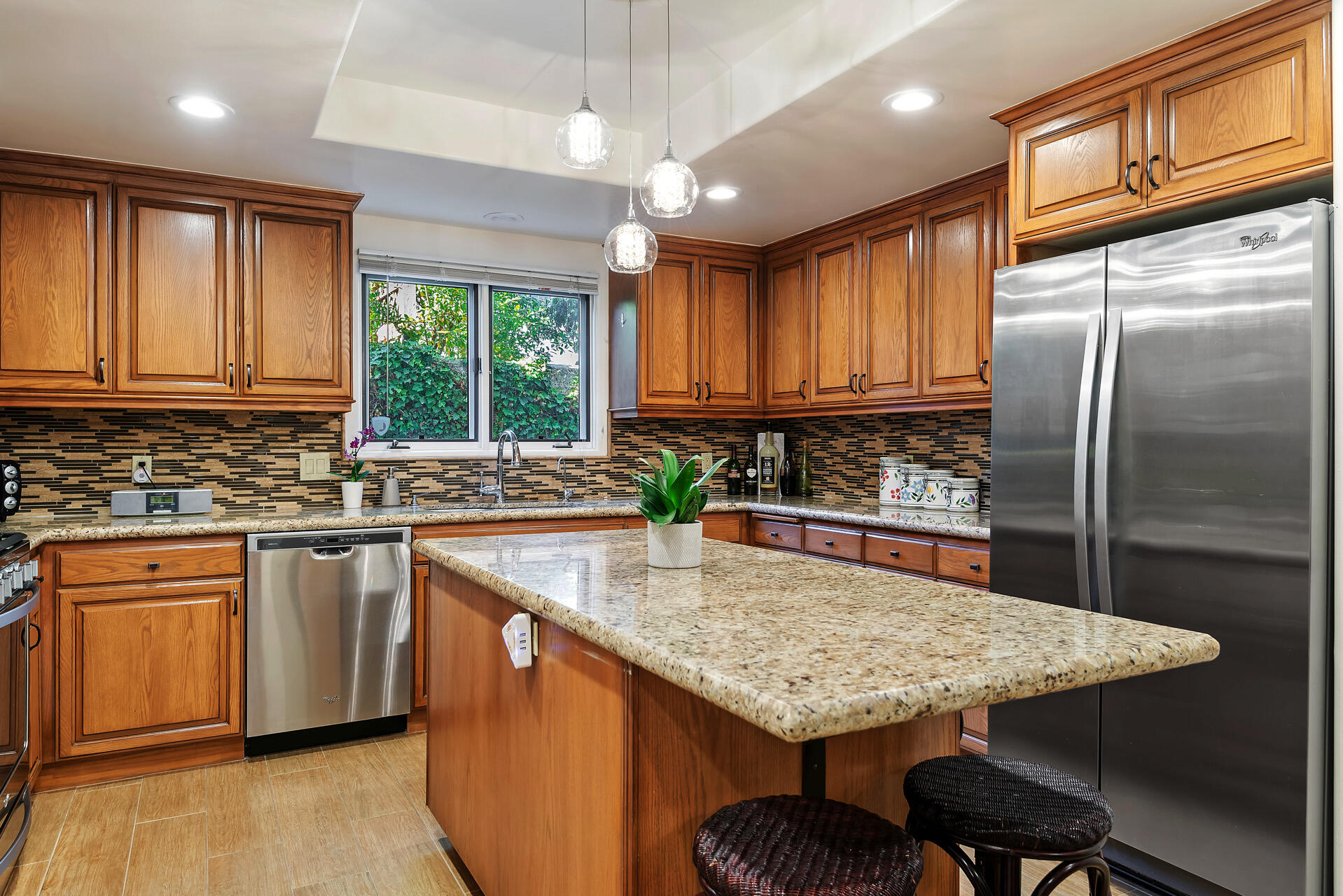 Undisclosed Address Santa Barbara, CA 93101 - Photo 4 of 25 a kitchen with stainless steel appliances granite countertop a stove a sink dishwasher a refrigerator and cabinets with wooden floor