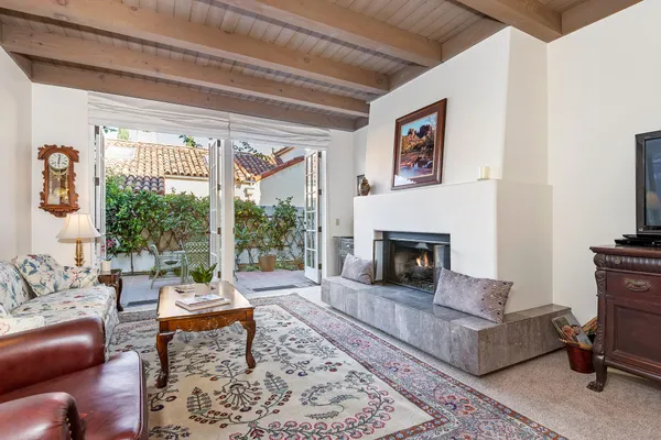 a living room with furniture a rug and a fireplace