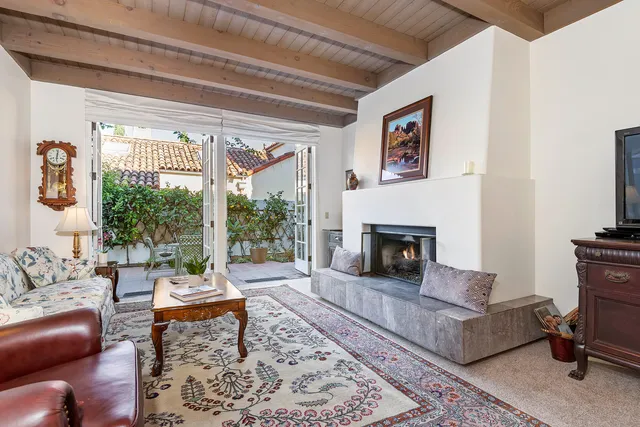 a living room with furniture a rug and a fireplace