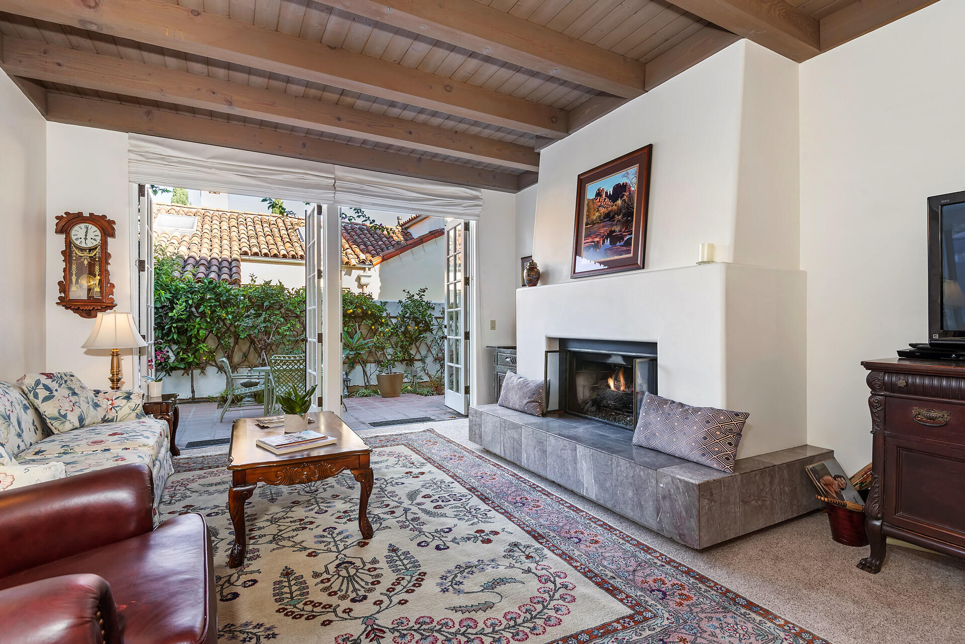 Undisclosed Address Santa Barbara, CA 93101 - Photo 10 of 25 a living room with furniture a rug and a fireplace
