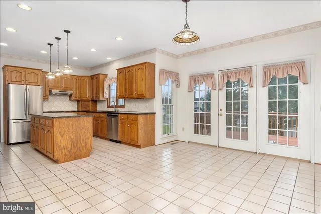 a view of an empty room with a fireplace and a window