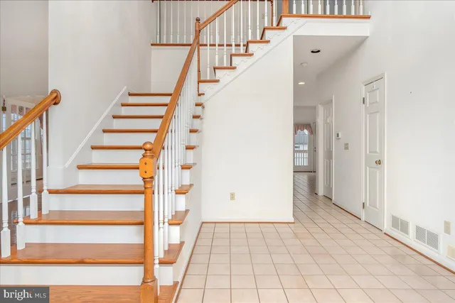 a view of entryway with wooden floor and stairs